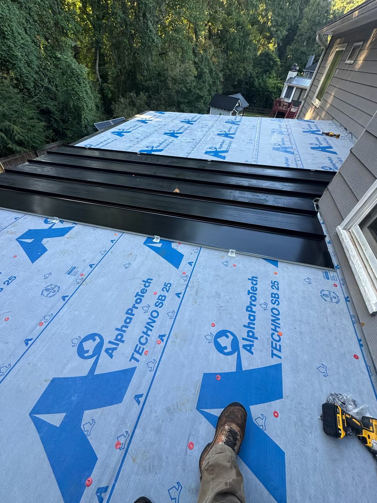 Standing seam metal panels going on over synthetic underlayment